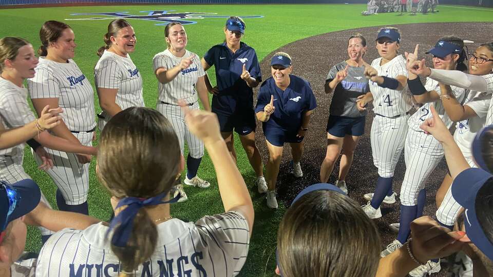 Kingwood coaches and players signal '1' for one win away from the state softball tournament following a walk-off 6-3 Game 1 win in their regional final series against Katy on Thursday at Kingwood High School.