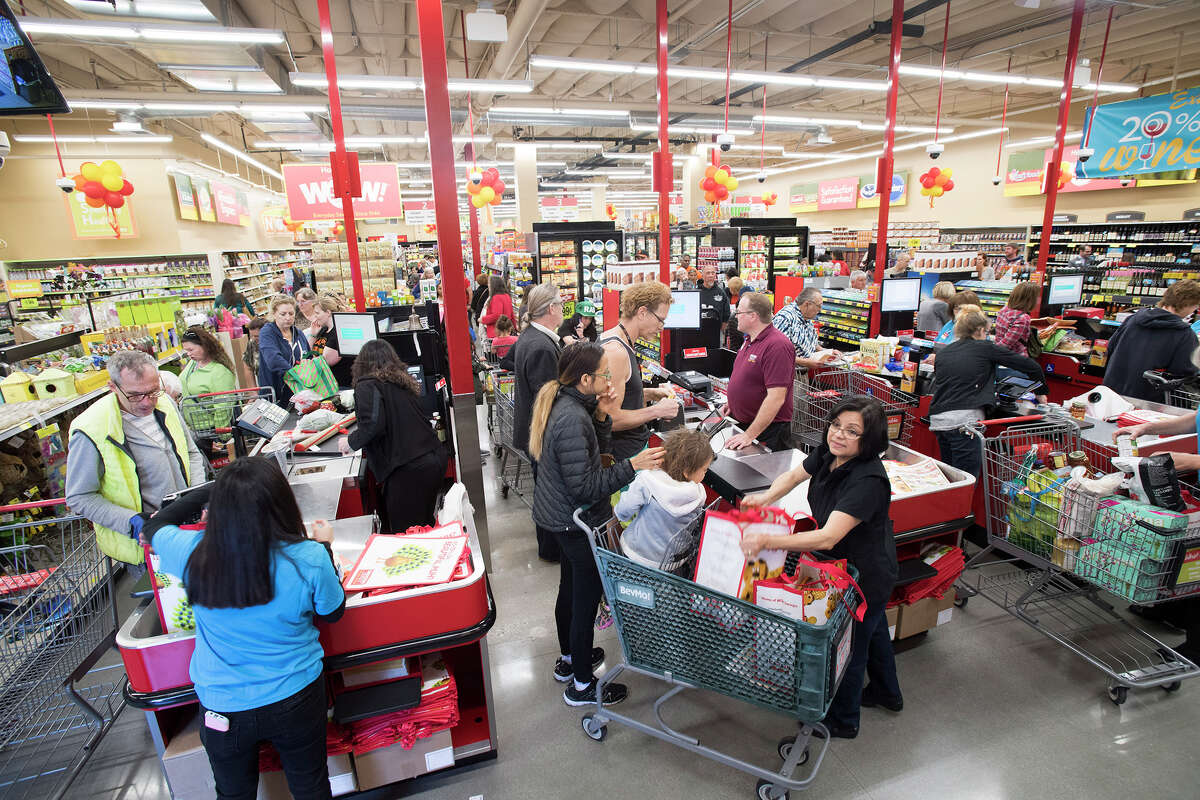 FILE: Shoppers check out from a Grocery Outlet Bargain Market in Huntington Beach, Calif.