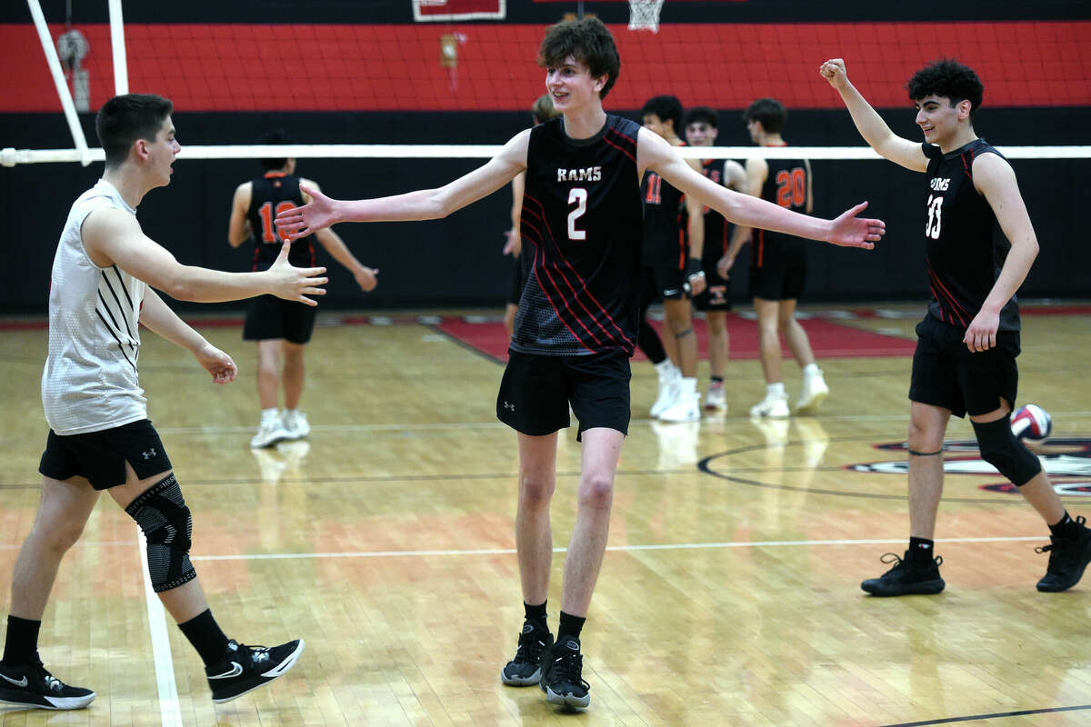 Connor Hayes, center, of Cheshire celebrates with teammates after defeating Shelton in the SCC Boys Volleyball Championship Game in Cheshire on May 24, 2024. Hayes was selected as the playoff’s Most Valuable Player.