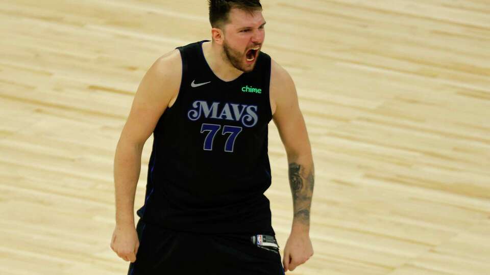 Dallas Mavericks guard Luka Doncic (77) celebrates after making a 3-point shot to take the lead against the Minnesota Timberwolves with seconds left during the second half of Game 2 of the NBA basketball Western Conference finals, Friday, May 24, 2024, in Minneapolis.