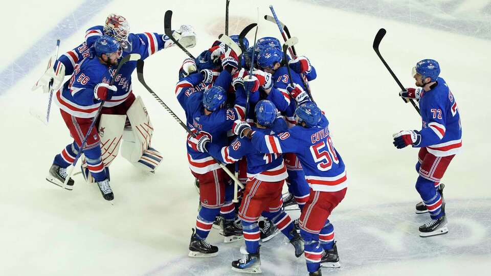 The New York Rangers celebrate after beating the Florida Panthers in overtime of Game 2 during the Eastern Conference finals of the NHL hockey Stanley Cup playoffs, Friday, May 24, 2024, in New York.