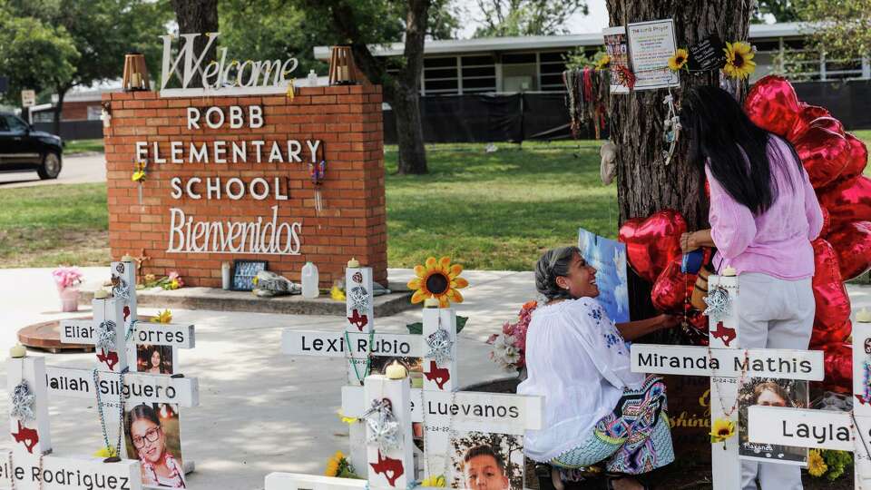 People add heart-shaped balloons to the makeshift memorial honoring the 21 victims of the Robb Elementary School shooting on Friday, May 24, 2024, in San Antonio, Texas. Friday marked two years since 19 fourth-graders and two teachers were killed by an 18-year-old gunman in the deadliest school shooting in Texas history.