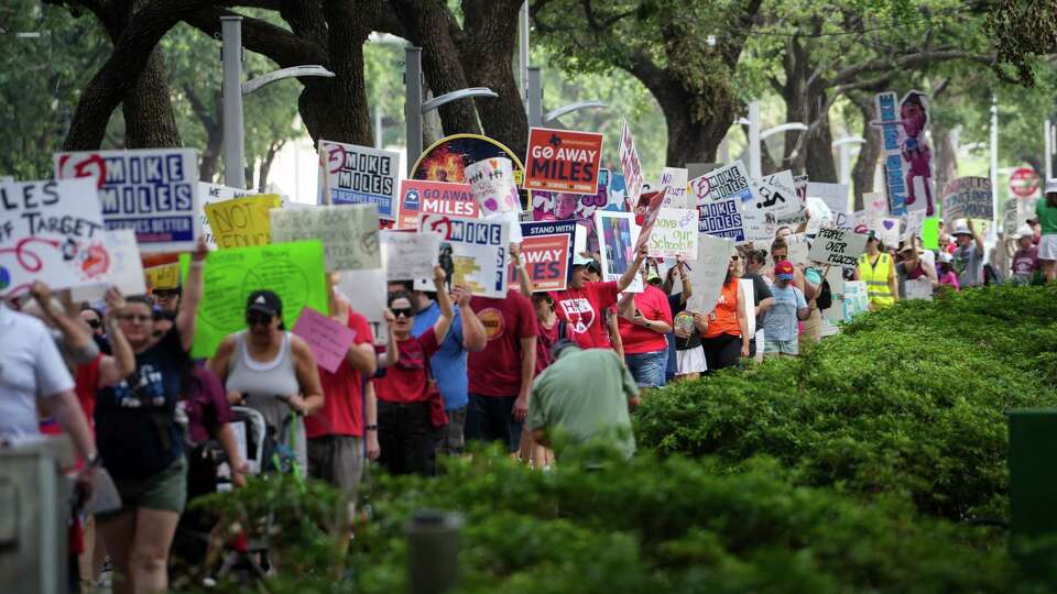 People yell and carry signs during a protest against Houston Independent School District Superintendent Mike Miles on Saturday, May 25, 2024, at Houston City Hall in Houston.