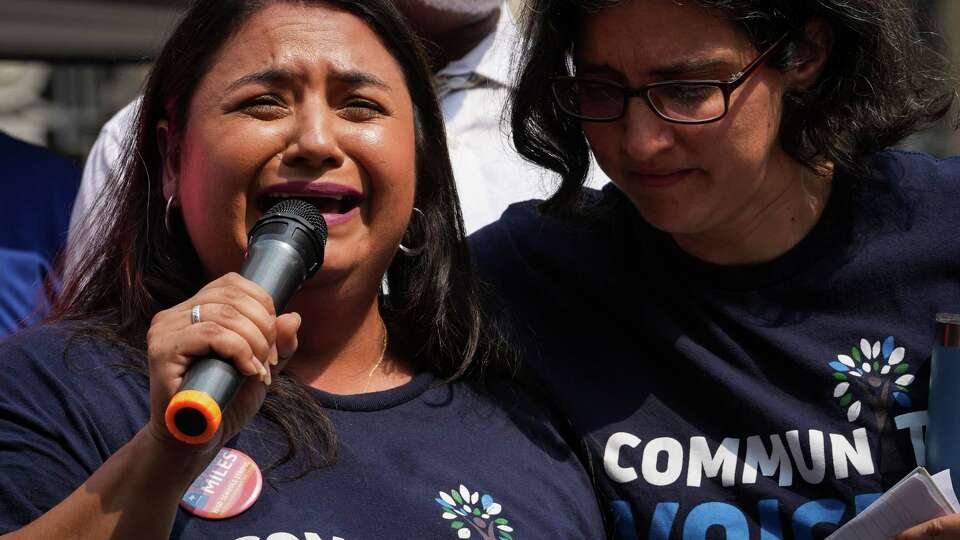 Jessica Campos, left, is comforted by a woman as she cries while speaking during a protest against Houston Independent School District Superintendent Mike Miles on Saturday, May 25, 2024, at Houston City Hall in Houston.