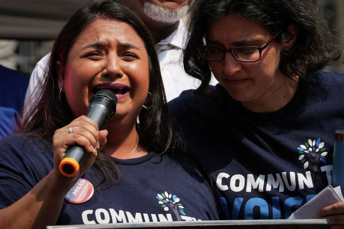 Jessica Campos, left, is comforted by a woman as she cries while speaking during a protest against Houston Independent School District Superintendent Mike Miles on Saturday, May 25, 2024, at Houston City Hall in Houston.