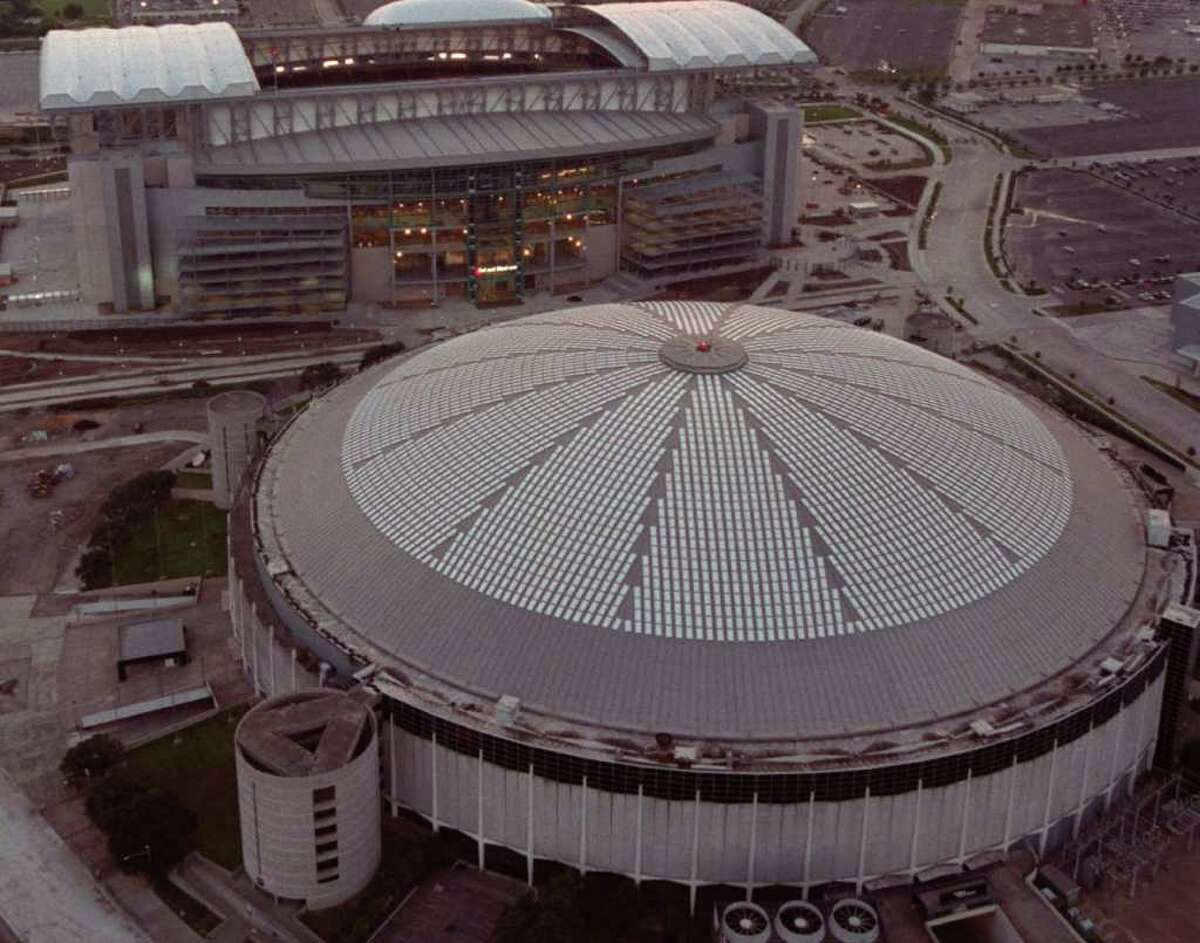 FILE - In this Aug. 2, 2002 file photo, an aerial view of Reliant Stadium, top, the new home of the Houston Texans and the Astrodome, bottom, former home of the Houston Oilers is shown in Houston. A $1.35 billion-dollar plan to turn the landmark Houston Astrodome into a convention and science center, but officials say at least two-thirds of the cost would have to be approved and picked up by taxpayers. Another option was unveiled Monday June 14, 2010, to raze the stadium. (AP Photo/Houston Chronicle, Smiley Pool, File)