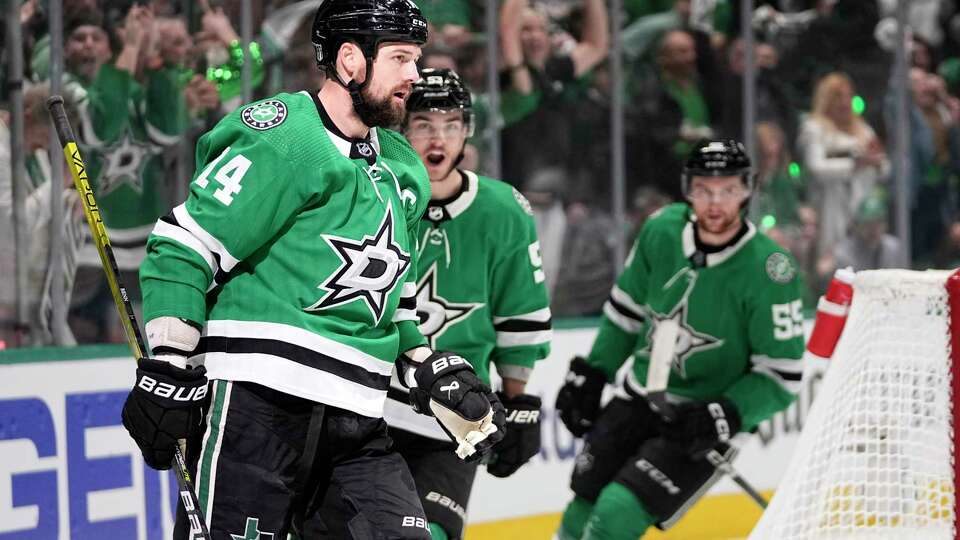 Dallas Stars left wing Jamie Benn (14), Wyatt Johnston, center, and Thomas Harley, right, celebrate after Benn scored during the first period in Game 2 of the Western Conference finals in the NHL hockey Stanley Cup playoffs against the Edmonton Oilers, Saturday, May 25, 2024, in Dallas.