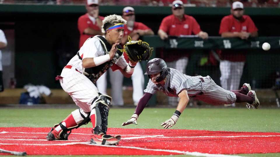 Pearland's shortstop Damian Landry (2) scores a run on John Moya's RBI double during the fourth inning of game 3 of a Region III-6A semifinal baseball game at Schroeder Park on Sunday, May 26, 2024, in Houston.