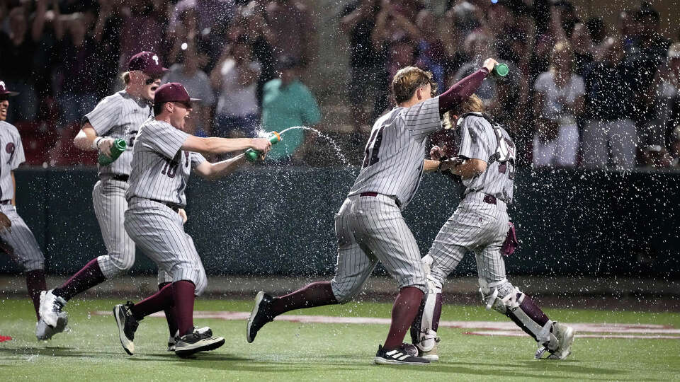 Pearland celebrates by running on the field spraying water on catcher Cade Adams after they beat Memorial 8-1 after game 3 of a Region III-6A semifinal baseball game at Schroeder Park on Sunday, May 26, 2024, in Houston.