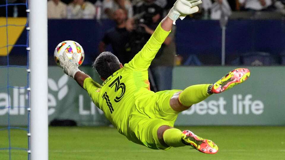 Houston Dynamo goalkeeper Andrew Tarbell can't reach a ball kicked for a goal by Los Angeles Galaxy midfielder Riqui Puig during the second half of a Major League Soccer match Saturday, May 25, 2024, in Carson, Calif.