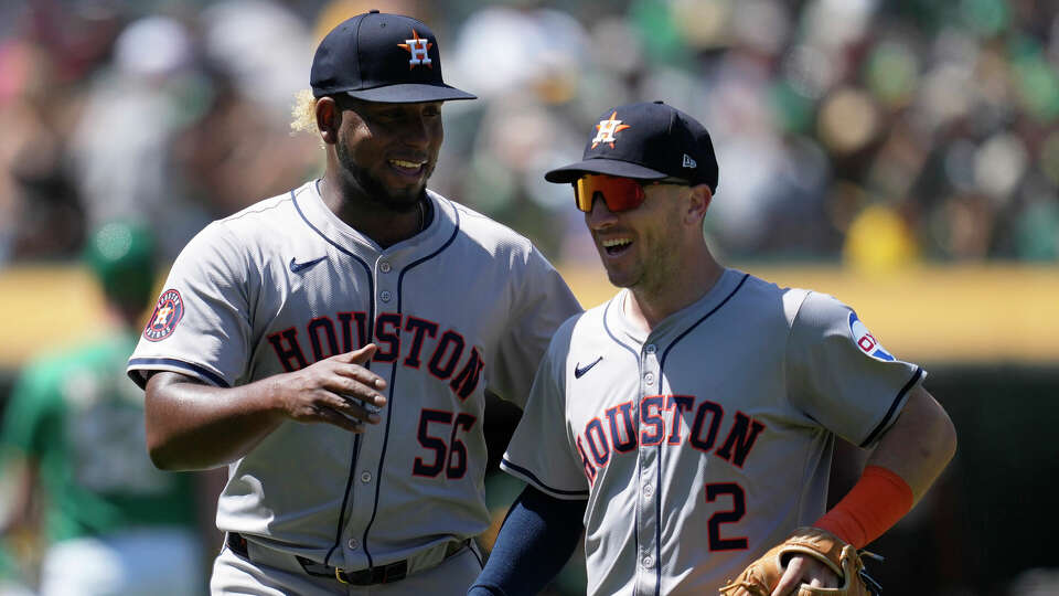 Houston Astros pitcher Ronel Blanco (56) smiles as he walks toward the dugout with third baseman Alex Bregman (2) after the seventh inning of a baseball game against the Oakland Athletics in Oakland, Calif., Sunday, May 26, 2024. (AP Photo/Jeff Chiu)