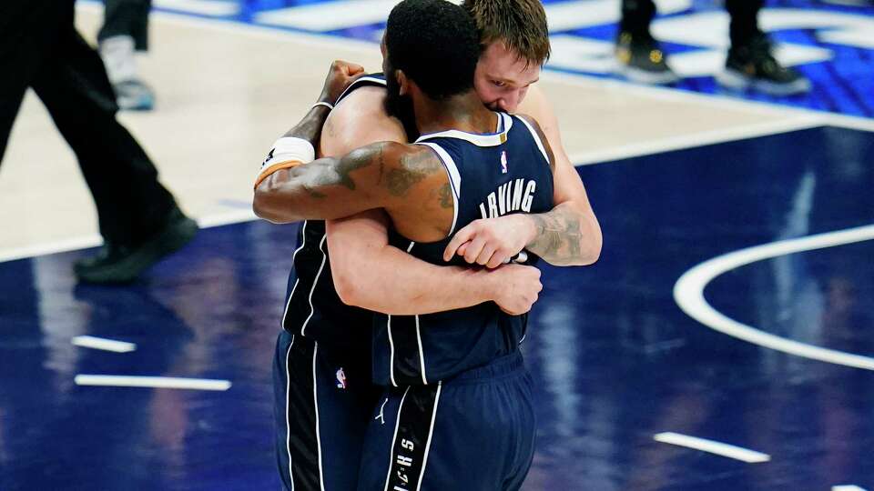 Dallas Mavericks guard Luka Doncic, left, and guard Kyrie Irving, right, embrace after their win over theMinnesota Timberwolves in Game 3 of the NBA basketball Western Conference finals, Sunday, May 26, 2024, in Dallas.