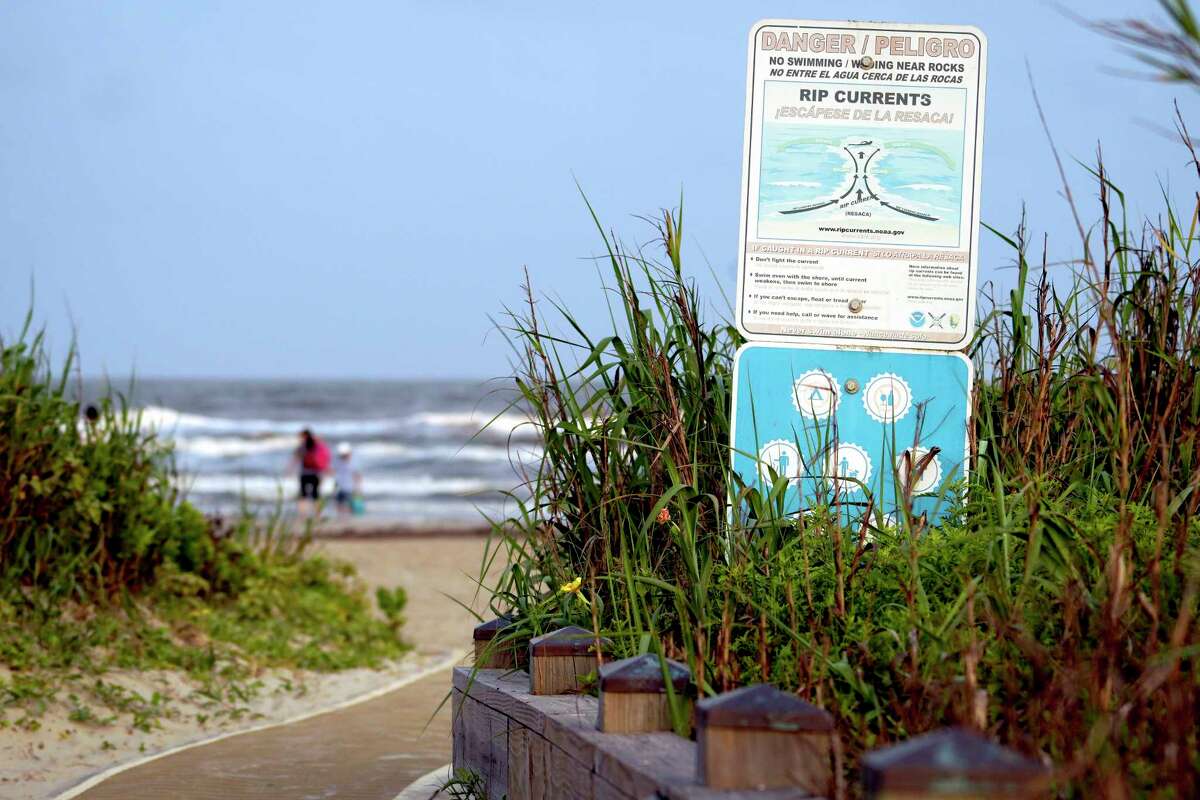 A sign warning of rip currents is posted near a public entrance to East Beach on Sunday, May 26, 2024 in Galveston, TX.