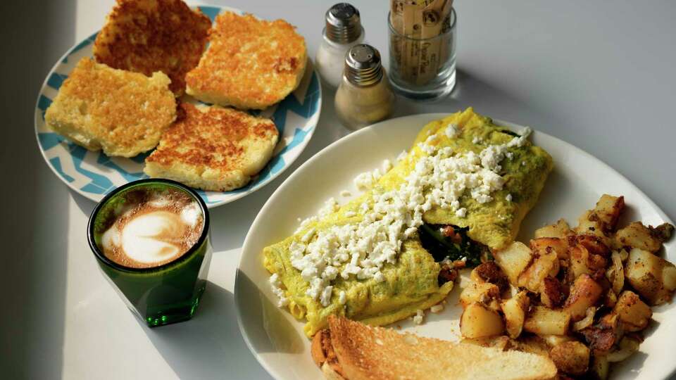 The Greek omelet and hash browns, grilled biscuits and cortado at Harry's are photographed Monday, May 27, 2024 in Houston.