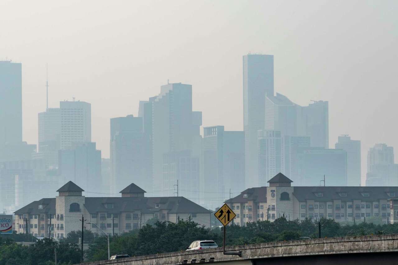 Looking north from Interstate 45 Gulf Freeway, only the silhouettes of buildings are visible as a blanket of haze settles over downtown Houston Monday, May 27, 2024.