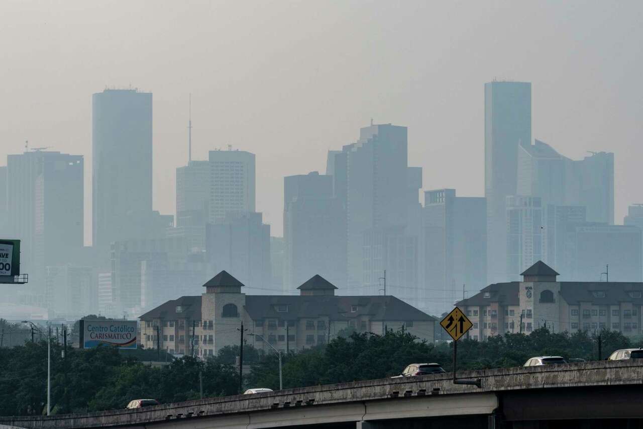 Looking north from Interstate 45 Gulf Freeway, only the silhouettes of buildings are visible as a blanket of haze settles over downtown Houston Monday, May 27, 2024.