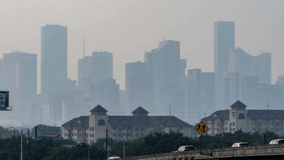 Looking north from Interstate 45 Gulf Freeway, only the silhouettes of buildings are visible as a blanket of haze settles over downtown Houston Monday, May 27, 2024.