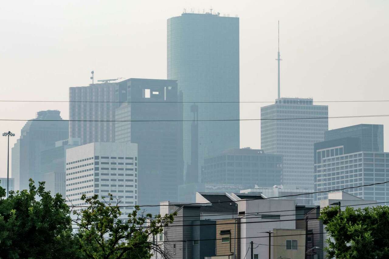 Only the silhouettes of buildings are visible as a blanket of haze settles over downtown Houston Monday, May 27, 2024.