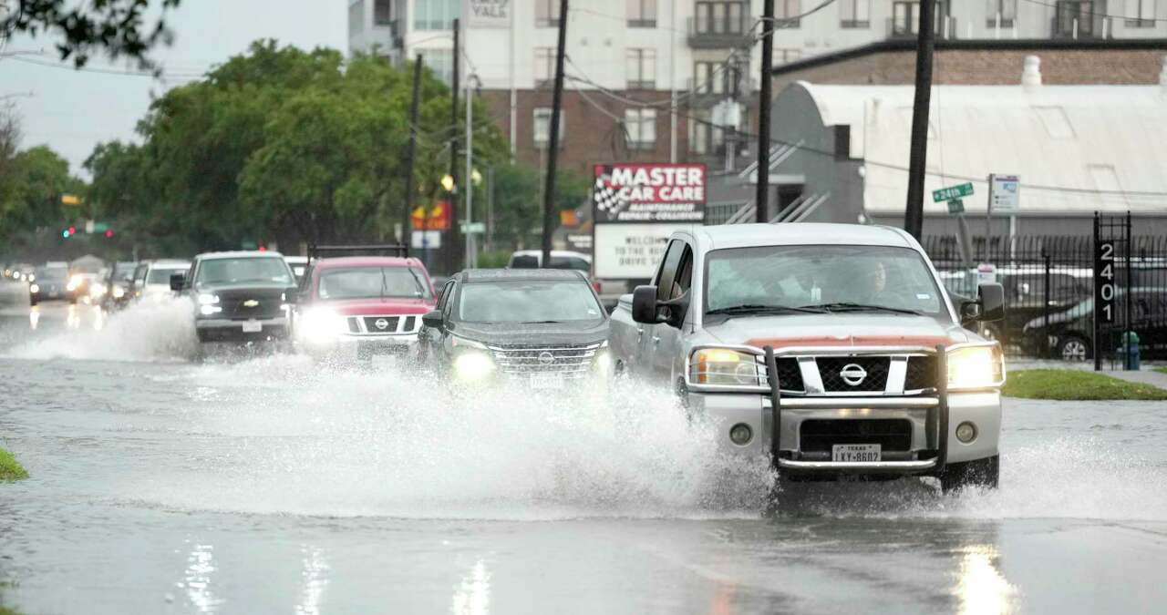 Drivers navigate high water on Yale Street in the Heights after a strong storm blew in on Tuesday, May 28, 2024, in Houston.