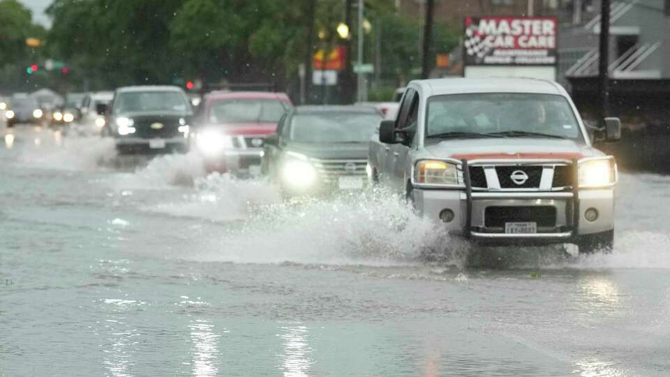 Drivers navigate high water on Yale Street in the Heights after a strong storm blew in on Tuesday, May 28, 2024, in Houston.