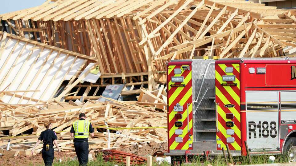 Magnolia Fire officials investigate the scene of a collapsed house that resulted in a fatality on Tuesday, May 28, 2024 in Magnolia. One construction worker was killed when the frames of two single-family homes that were under construction fell as a strong, fast-moving storm moved across Montgomery County, officials said.