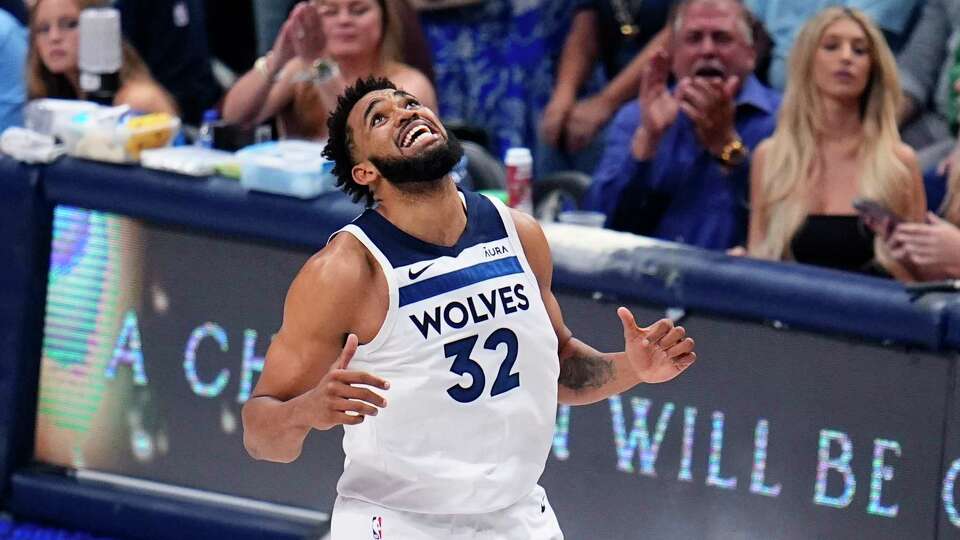 Minnesota Timberwolves center Karl-Anthony Towns (32) reacts to a play during the second half in Game 4 of the NBA basketball Western Conference finals against the Dallas Mavericks, Tuesday, May 28, 2024, in Dallas.