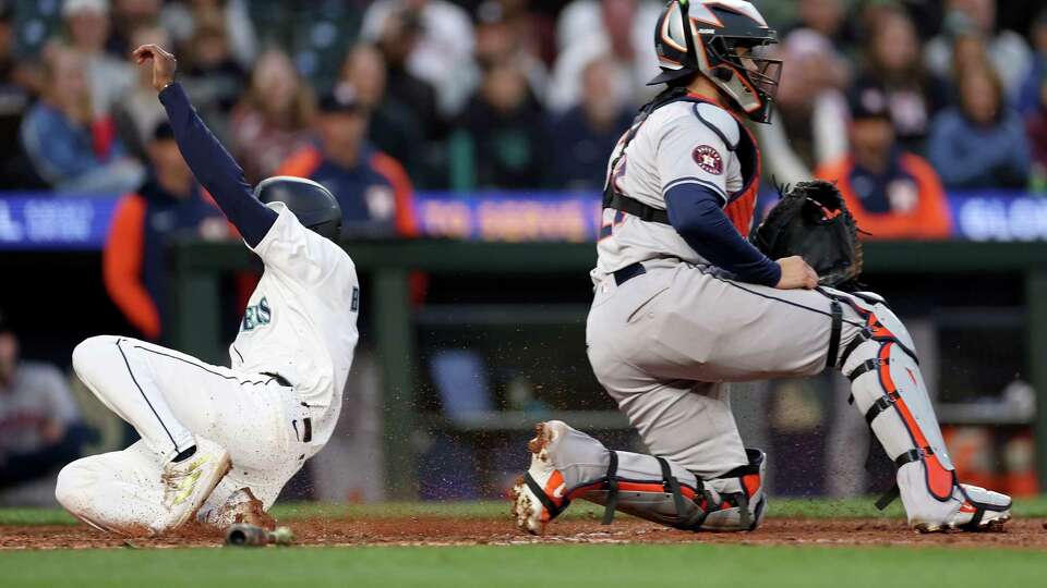 SEATTLE, WASHINGTON - MAY 28: Ryan Bliss #1 of the Seattle Mariners scores a run against the Houston Astros during the eighth inning at T-Mobile Park on May 28, 2024 in Seattle, Washington.