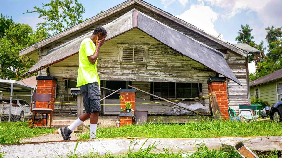 Don Parker walks past the collapsed front porch at his home, that currently has just a small generator providing limited power, on Wednesday, May 29, 2024 in Houston. Parker lost power May 16 due to storm damage to his individual equipment that CenterPoint doesn't take responsibility for. The lights never came back on; he has applied for FEMA aid to help with repairs, he said.