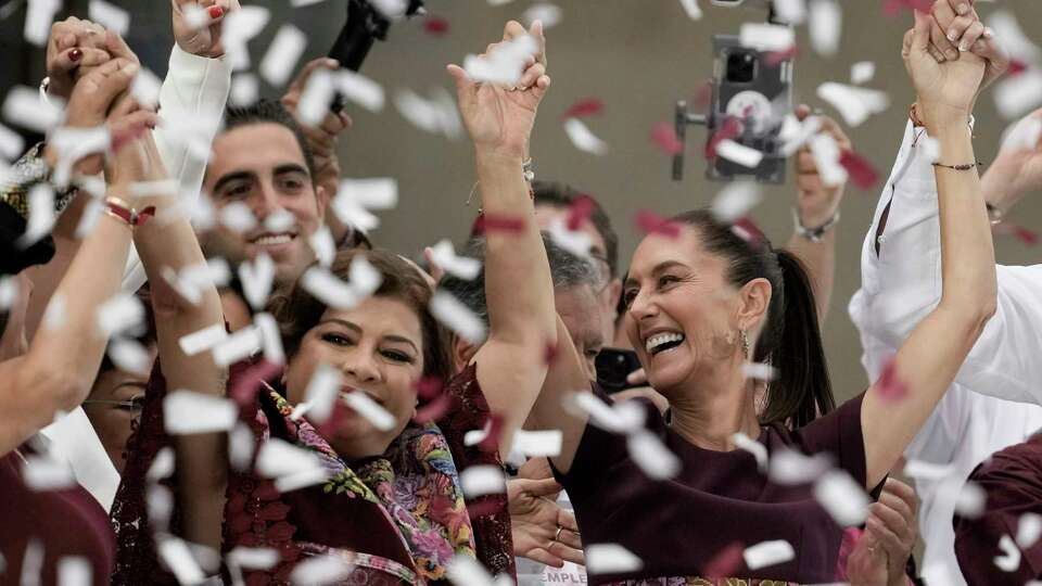 Presidential candidate Claudia Sheinbaum, right, and Mexico City mayoral candidate Clara Brugada raise their arms during Sheinbaum's closing campaign rally at the Zocalo in Mexico City, Wednesday, May 29, 2024. Mexico's general election is set for June 2. (AP Photo/Eduardo Verdugo)