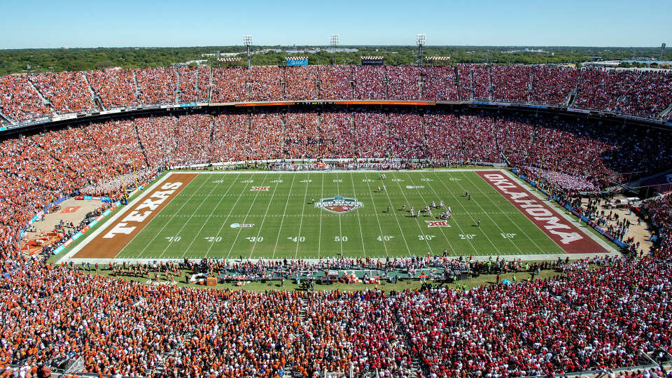 In this Oct. 12, 2019, file photo, Texas and Oklahoma fans fill the Cotton Bowl during the first half of an NCAA college football game in Dallas. (AP Photo/Jeffrey McWhorter, File)