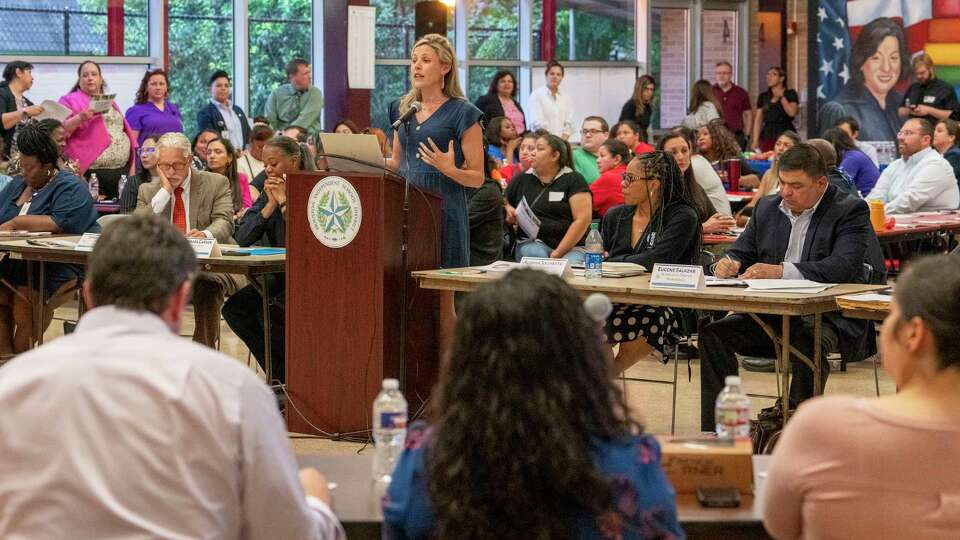 HISD senior staff members sit adjacent to HISD Chief Academic Officer Kristen Hole, as she speaks to Community Advisory Board members regarding a multi billion dollar bond package during a meeting in the south HISD division Thursday, May 30, 2024 at Cornelius Elementary School in Houston.