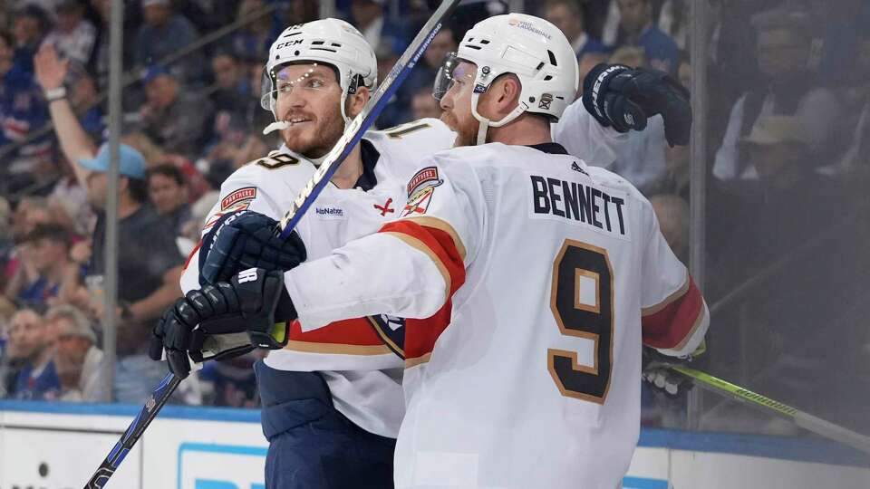 Florida Panthers' Matthew Tkachuk, left, celebrates with Sam Bennett after Bennett scored an empty-net goal against the New York Rangers during the third period of Game 5 in the Eastern Conference finals of the NHL hockey Stanley Cup playoffs Thursday, May 30, 2024, in New York, N.Y. The Panthers won 3-2.