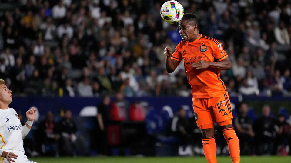 Houston Dynamo forward Latif Blessing, right, heads the ball as LA Galaxy midfielder Riqui Puig defends during the first half of a Major League Soccer match Saturday, May 25, 2024, in Carson, Calif. (AP Photo/Mark J. Terrill)