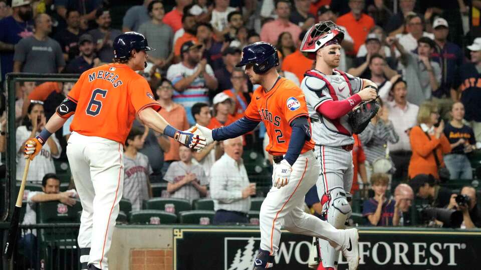 Houston Astros Alex Bregman (2) celebrates his home run with Jake Meyers (6) during the fourth inning of an MLB baseball game at Minute Maid Park on Saturday, June 1, 2024, in Houston.