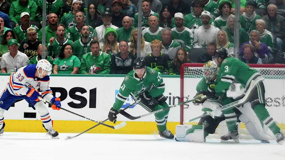 Edmonton Oilers center Ryan Nugent-Hopkins (93) shoots and scores as Dallas Stars' Ty Dellandrea (10), goalie Jake Oettinger (29), and Chris Tanev (3) defend the net during the first period of Game 5 of the Western Conference finals in the NHL hockey Stanley Cup playoffs Friday, May 31, 2024, in Dallas.