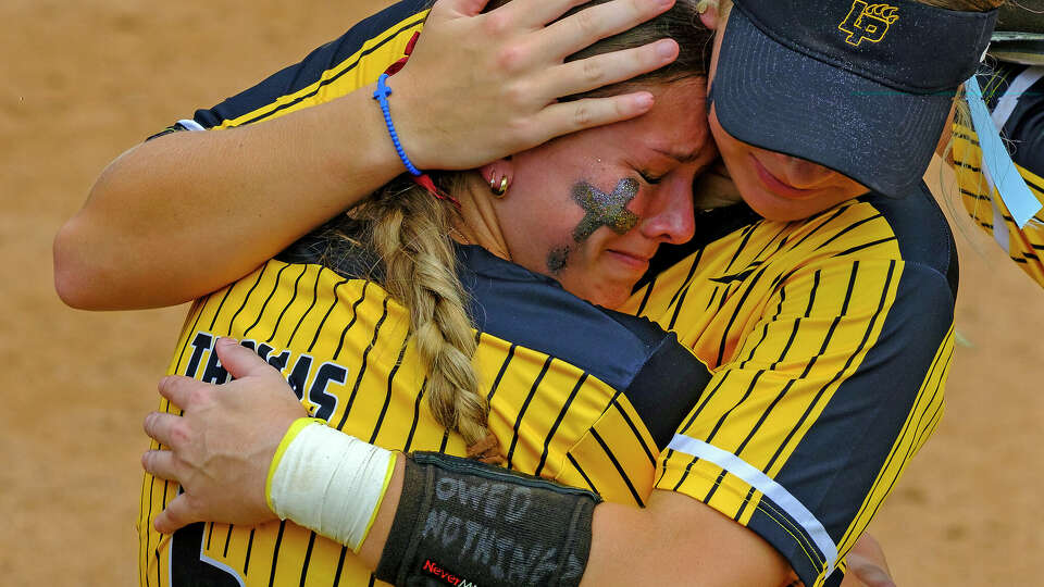 Liberty Hollie Thomas, (6), is comforted by Abby Vickers, (14), after losing 2-1 to Calallen in the 2024 UIL 4A softball championship, Saturday, June 1, 2024, in Austin. (Rodolfo Gonzalez for the Houston Chronicle)