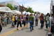 Attendees of the Art Fair walk through the main street, looking at the variety of artists.