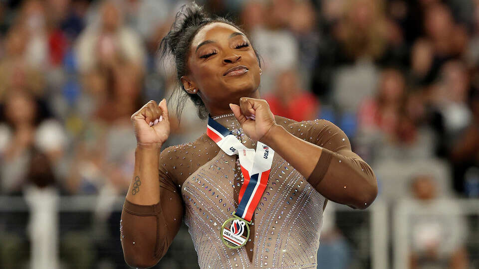 First place winner Simone Biles celebrates on the podium for the uneven bars during the 2024 Xfinity U.S. Gymnastics Championships at Dickies Arena on June 02, 2024 in Fort Worth, Texas. (Photo by Elsa/Getty Images)