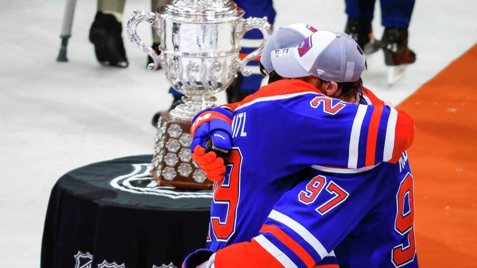 Edmonton Oilers forward Connor McDavid (97) and forward Leon Draisaitl (29) embrace after defeating the Dallas Stars in Game 6 of the Western Conference finals of the NHL hockey Stanley Cup playoffs in Edmonton, Alberta, Sunday, June 2, 2024. (Jeff McIntosh/The Canadian Press via AP)