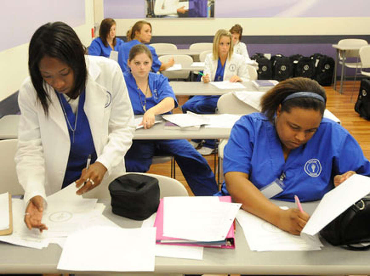 Medical assistant students Staci Mott, left, and Karentheus Savoy, right, look over notes from their Allied Health class at Kaplan College on Dowlen Road in the Parkdale Mall. Valentino Mauricio/The Enterprise