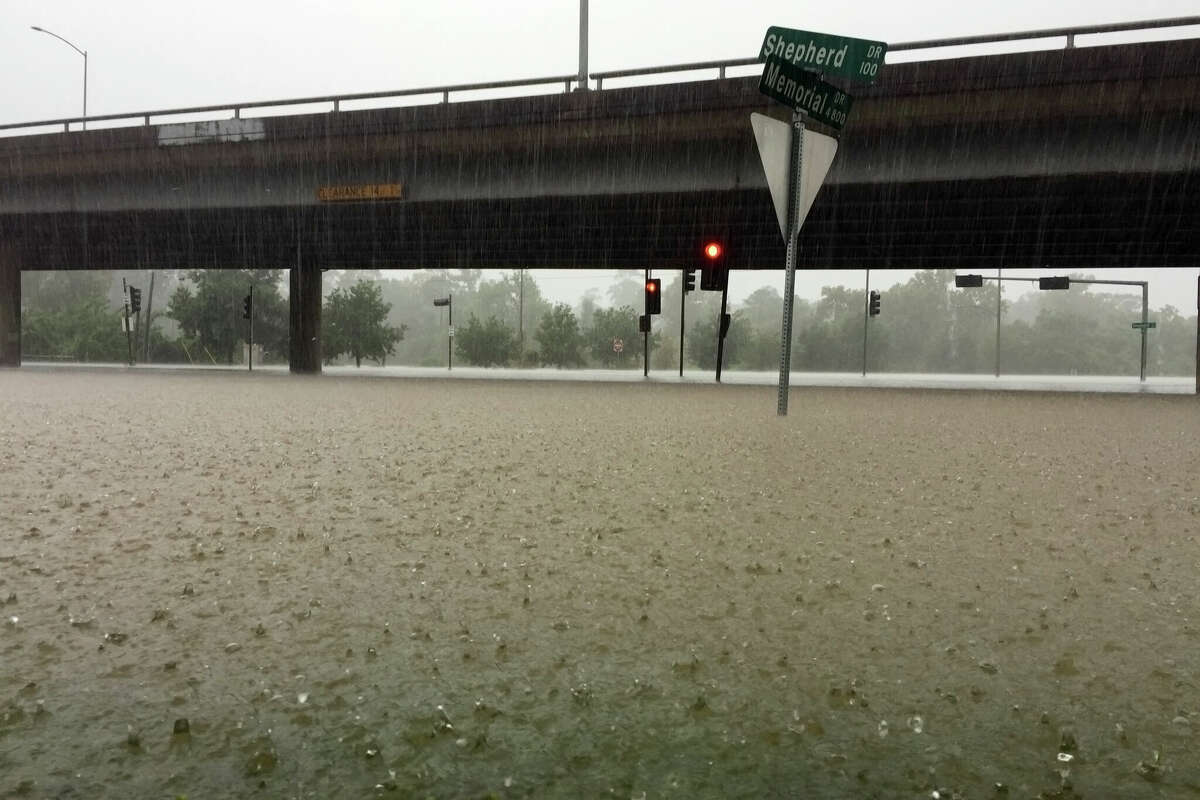 Heavy rain pouring down and flooding a major intersection during Hurricane Harvey.