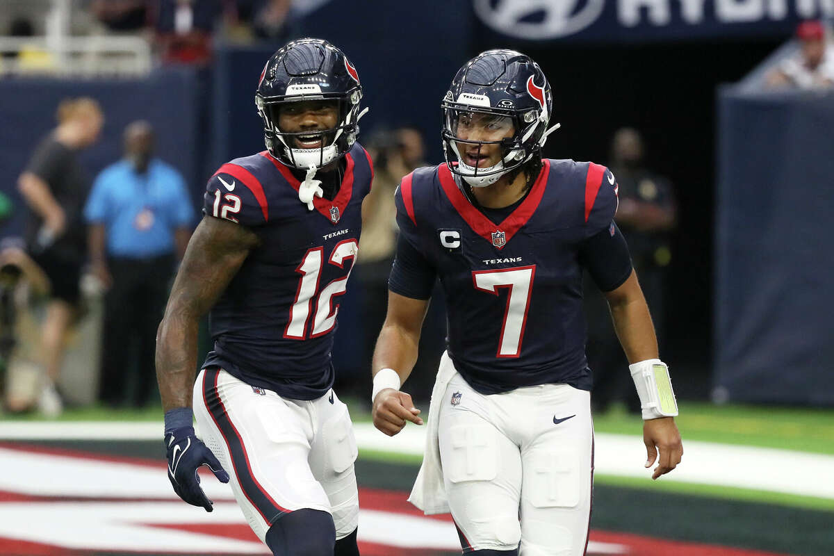 Nico Collins #12 of the Houston Texans and C.J. Stroud #7 react after a touchdown in the first quarter of a game against the Tampa Bay Buccaneers at NRG Stadium on November 05, 2023 in Houston, Texas. 