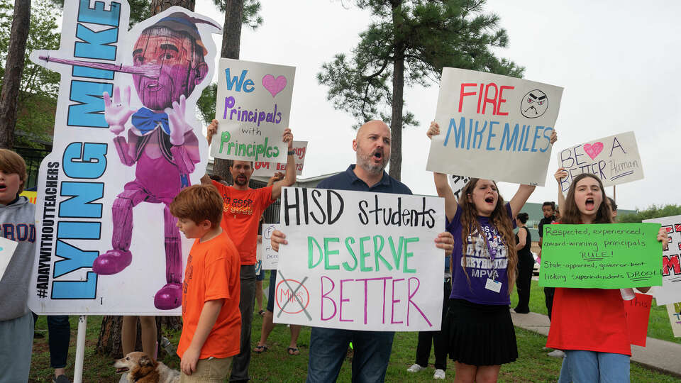 Robbie McDonough, a parent of students at Meyerland Performing and Visual Arts Middle School and Herod Elementary School, center, protests outside Herod Elementary School in the in the Maplewood/Meyerland West area in Southwest Houston, TX on Wednesday, May 22, 2024. Parents say their principal and several teachers are being being forced out.