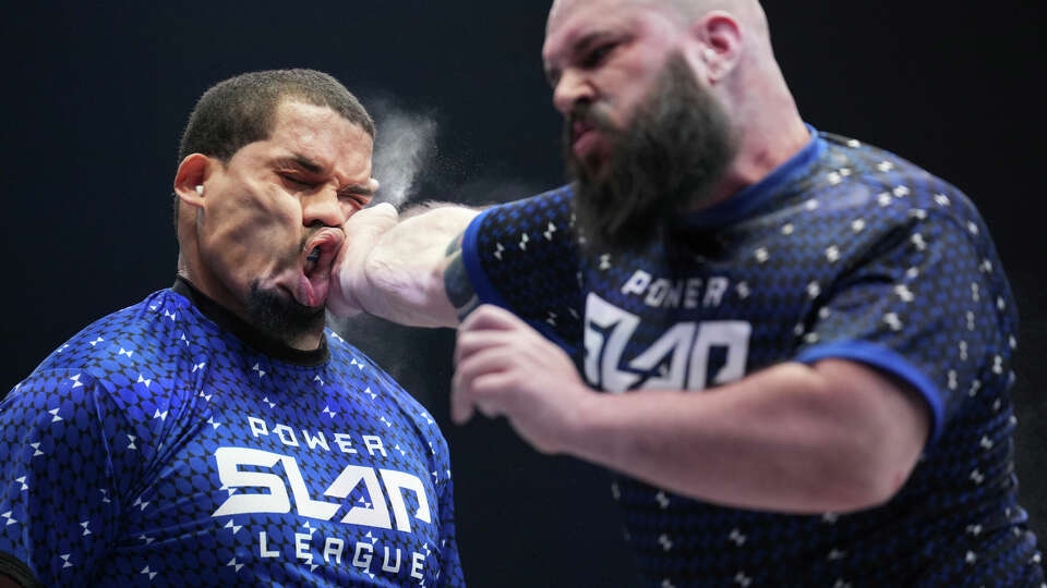 In this photo provided by Zuffa LLC, Ryan Phillips slaps Rob Perez at a Power Slap event in Las Vegas, March 31, 2022. When the open-handed blow is delivered, there's a sharp report and the reaction can be dramatic. Some fighters barely move, while others stumble backward or fall to the floor. Some are knocked out. 