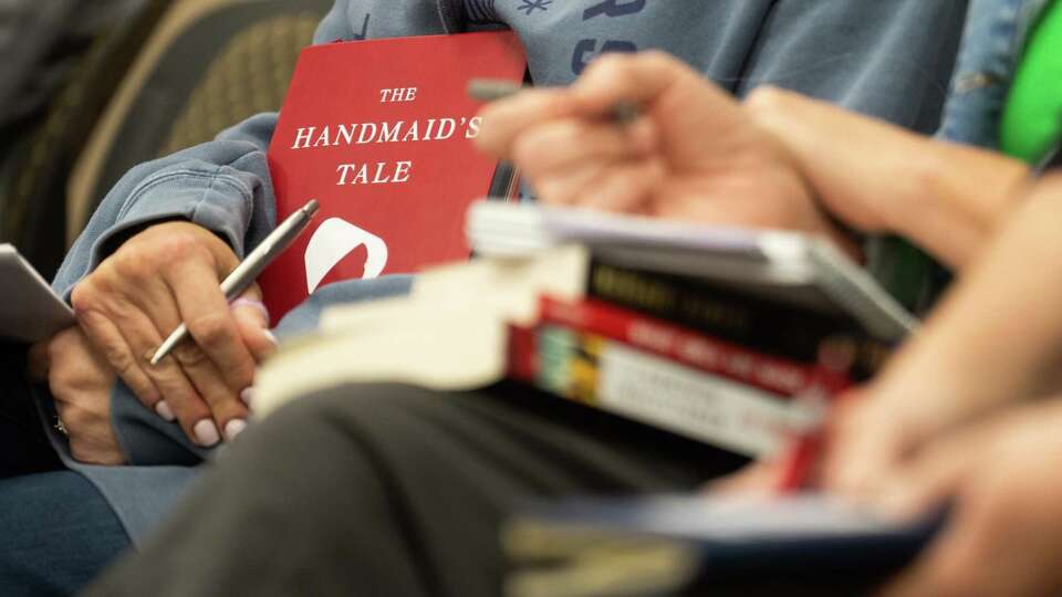 Tammy Marino holds a copy of Margaret Atwood's book 