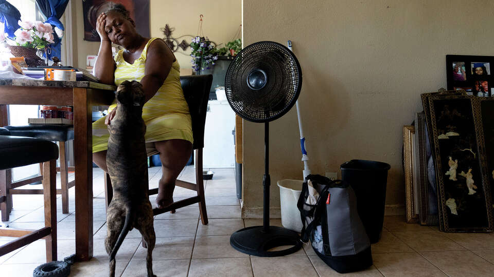 Frustrated and hot, Debra Watts wipes sweat from her face after another disappointing call looking for a new apartment July 7. Most apartments with openings do not accept housing vouchers, which Watts relies on. Watts's air conditioning hasn't worked in weeks and as temperatures stay in the triple digits she worries about her underlying health conditions and the wellbeing of her dog, Baby. Watts lives in the Seven Oaks apartment complex and like most residents in the complex, she has received a notice to vacate. Watts has become an active member of the tenants union she and other residents started with the help of Texas Organizing Project.