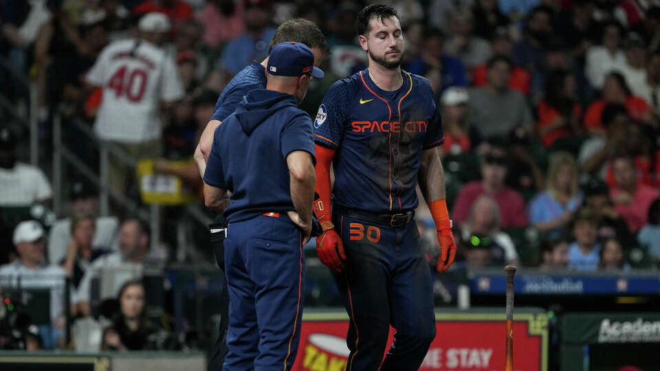 Houston Astros right fielder Kyle Tucker (30) is helped by staff after fouling a ball off himself during the third inning of an MLB game Monday, June 3, 2024, at Minute Maid Park in Houston.