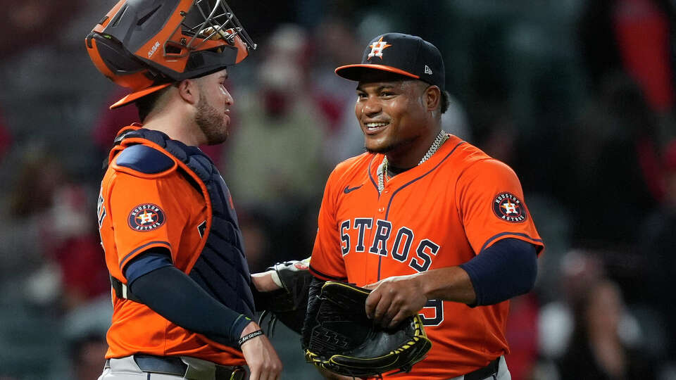 Houston Astros starting pitcher Framber Valdez, right, meets with catcher Victor Caratini after Valdez threw a four-hitter in the team's 7-1 win against the Los Angeles Angels in a baseball game Friday, June 7, 2024, in Anaheim, Calif. (AP Photo/Ryan Sun)