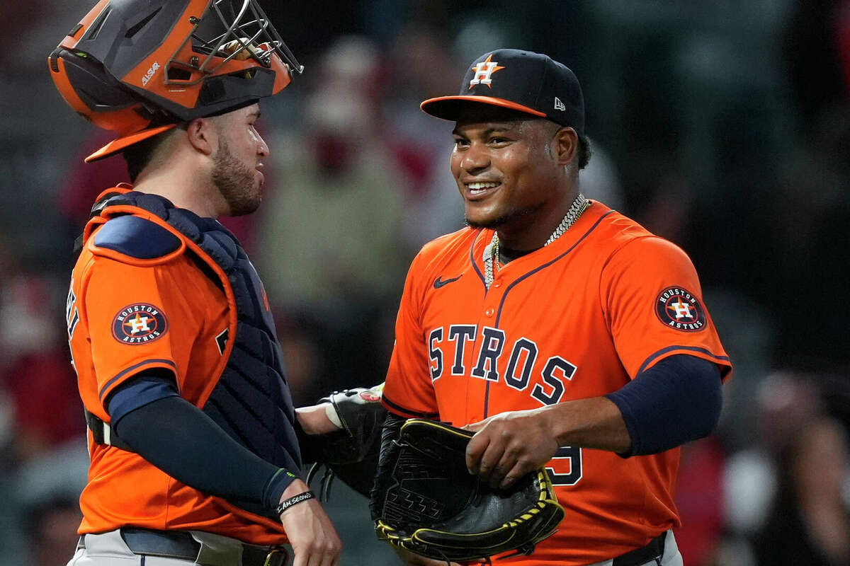 Houston Astros starting pitcher Framber Valdez, right, meets with catcher Victor Caratini after Valdez threw a four-hitter in the team's 7-1 win against the Los Angeles Angels in a baseball game Friday, June 7, 2024, in Anaheim, Calif. (AP Photo/Ryan Sun)