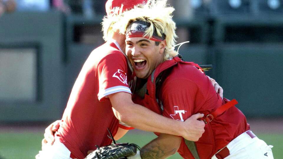 Tomball catcher Cade Arrambide, right, embraces starting pitcher Karson Reeder after defeating Pearland 4-1 in the Class 6A state championship during the UIL State Baseball Championships at Dell Dimond, Saturday, June 8, 2024, in Round Rock.